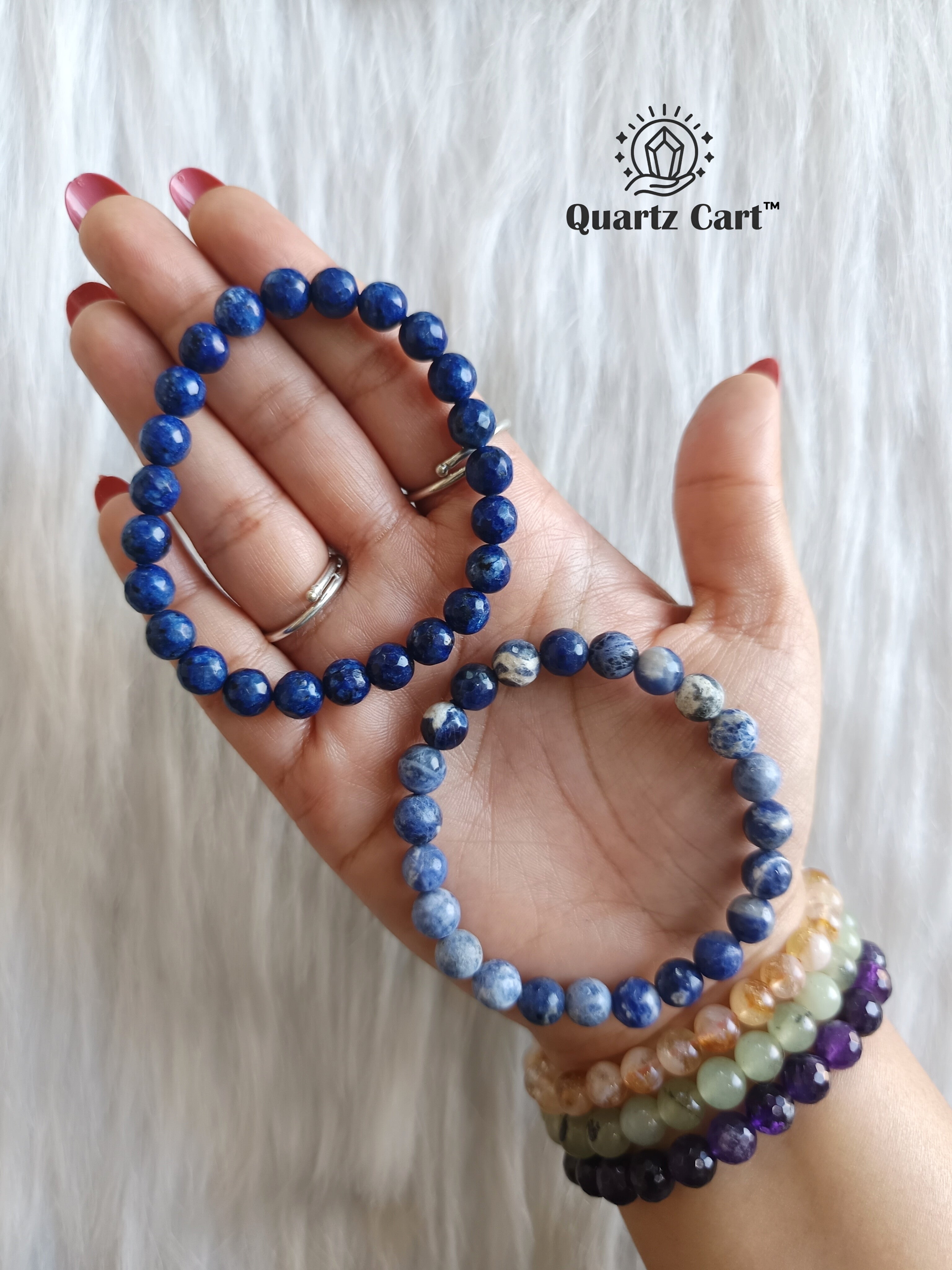 Sodalite faceted bracelet worn on hand showing polished blue gemstone beads, healing crystal bracelet for communication and focus