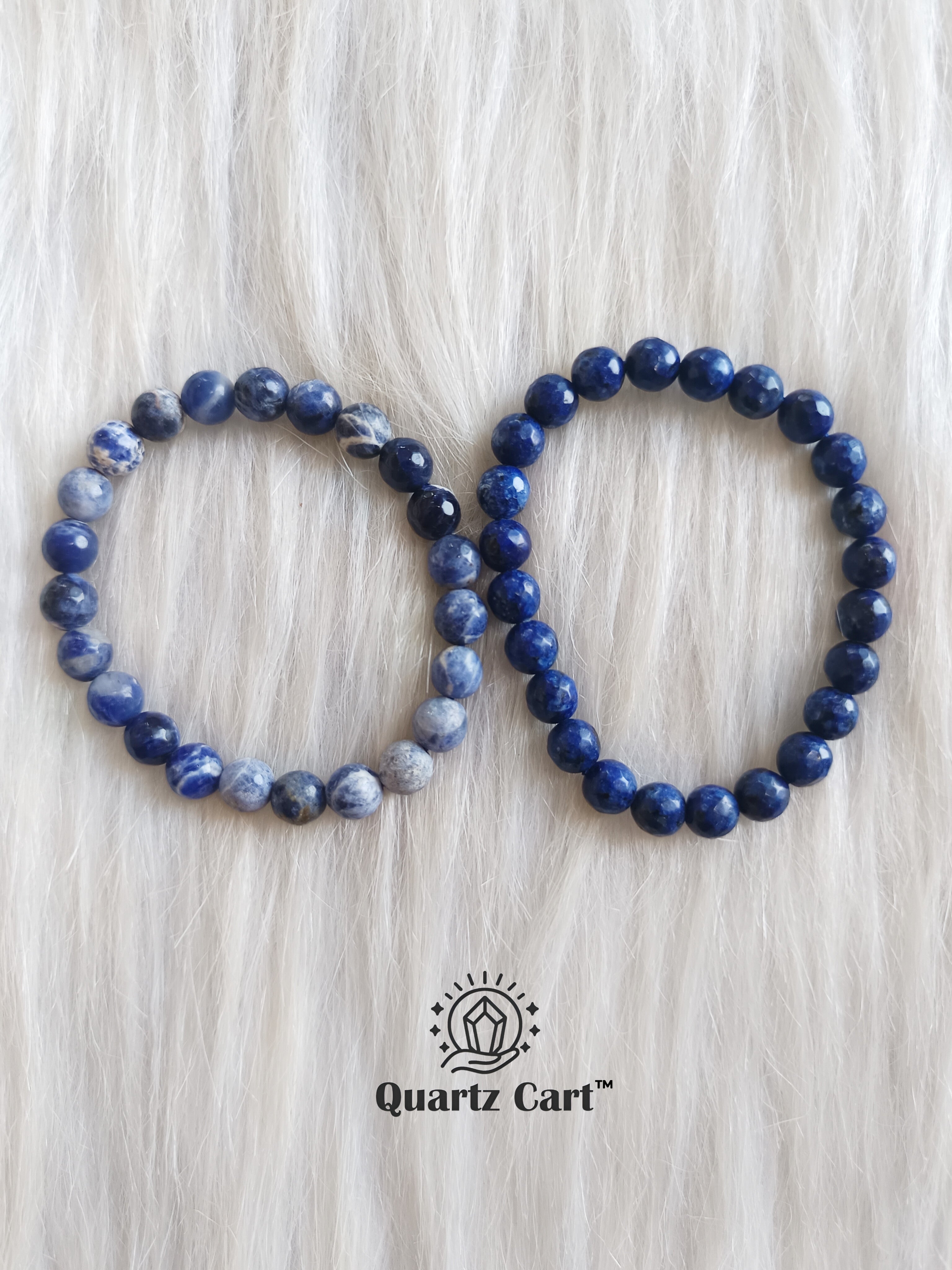 Sodalite faceted bracelets displayed on surface showing deep blue gemstone beads, healing crystal bracelet for clarity and communication