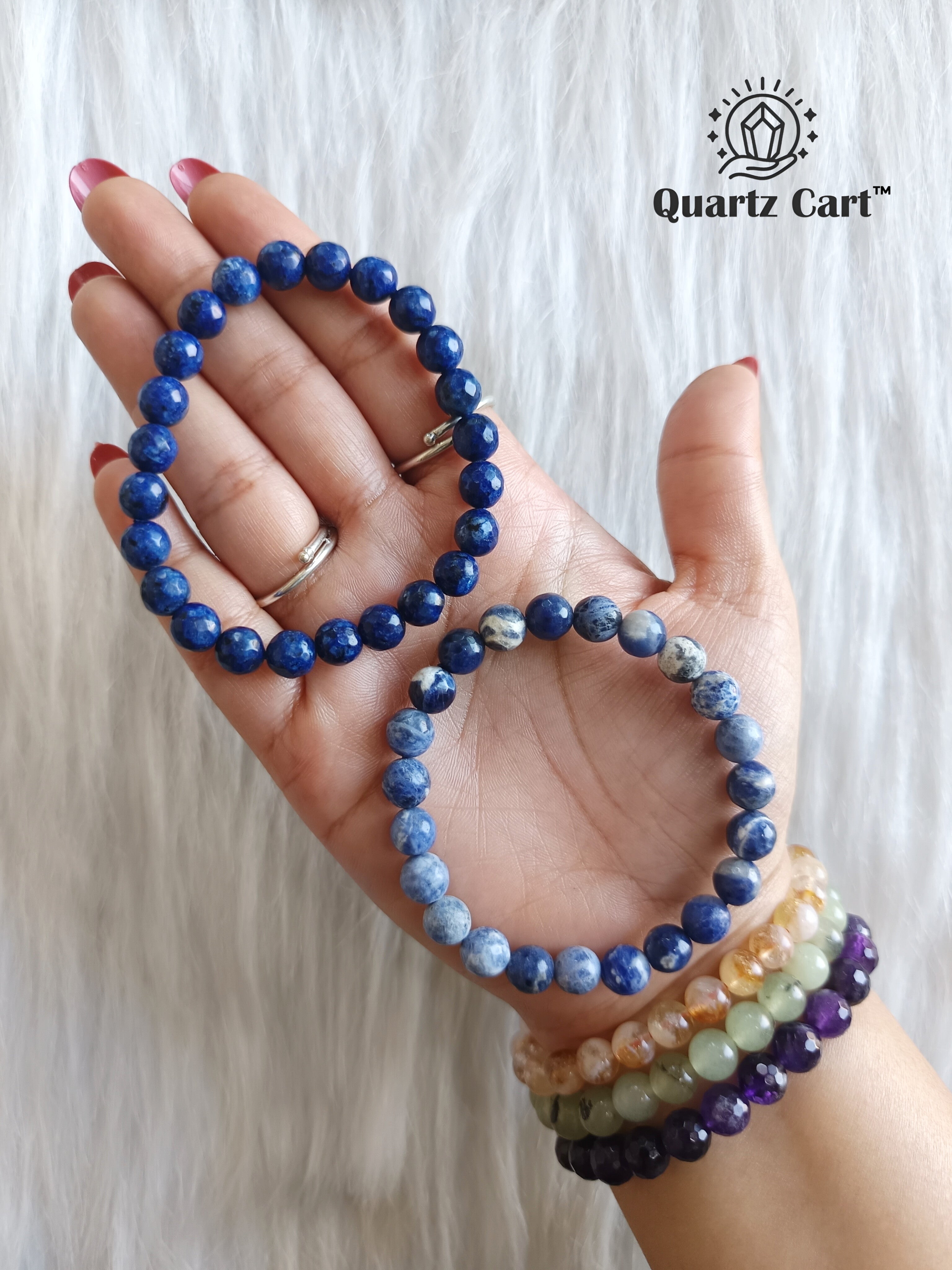 Sodalite faceted bracelets held on hand showing natural blue gemstone beads, crystal bracelet for mental clarity and emotional balance