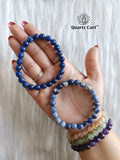 Hand holding Sodalite faceted crystal bracelet for clarity communication and emotional balance
