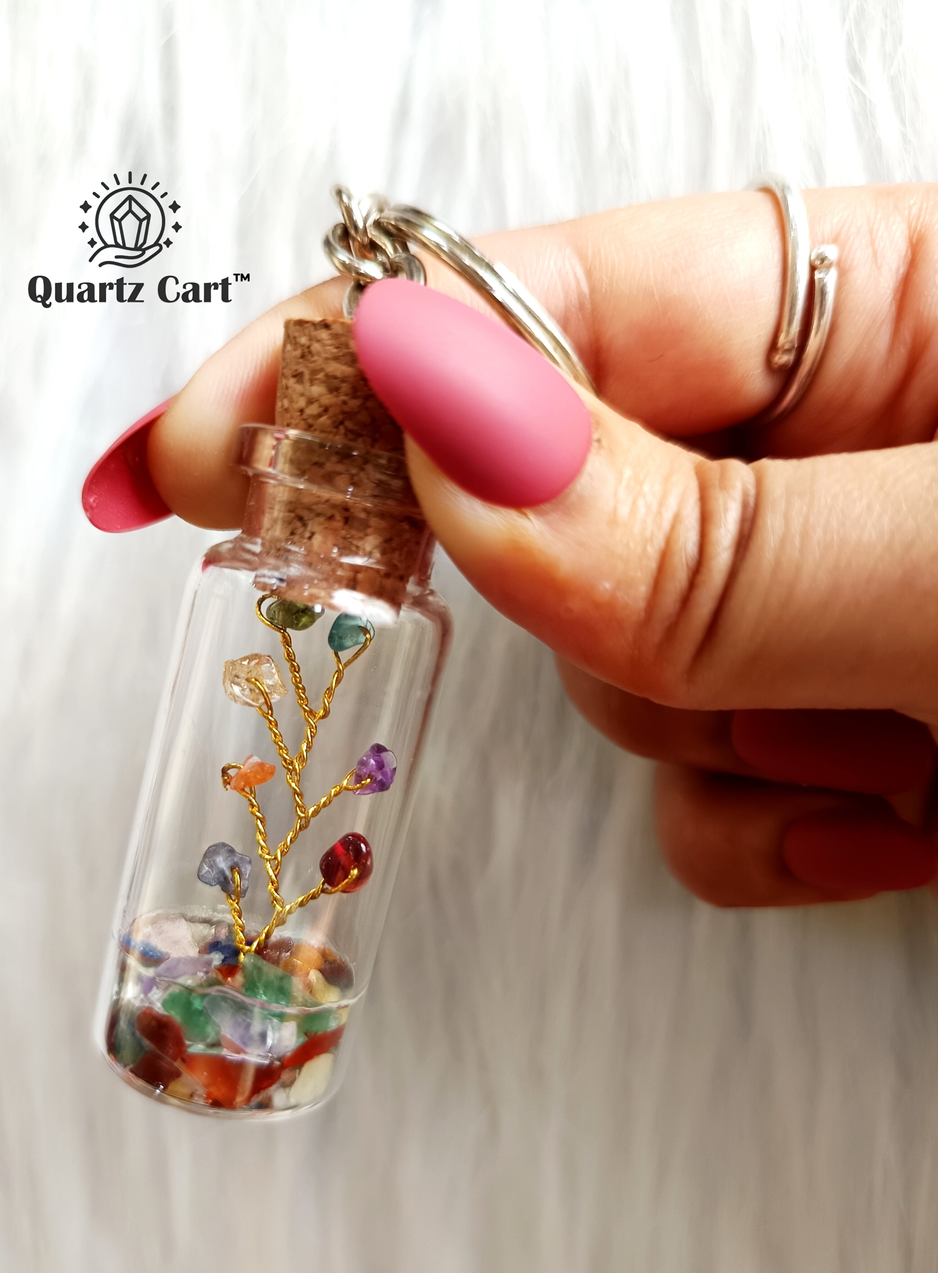 color stone chips bottle keychain held in hand
