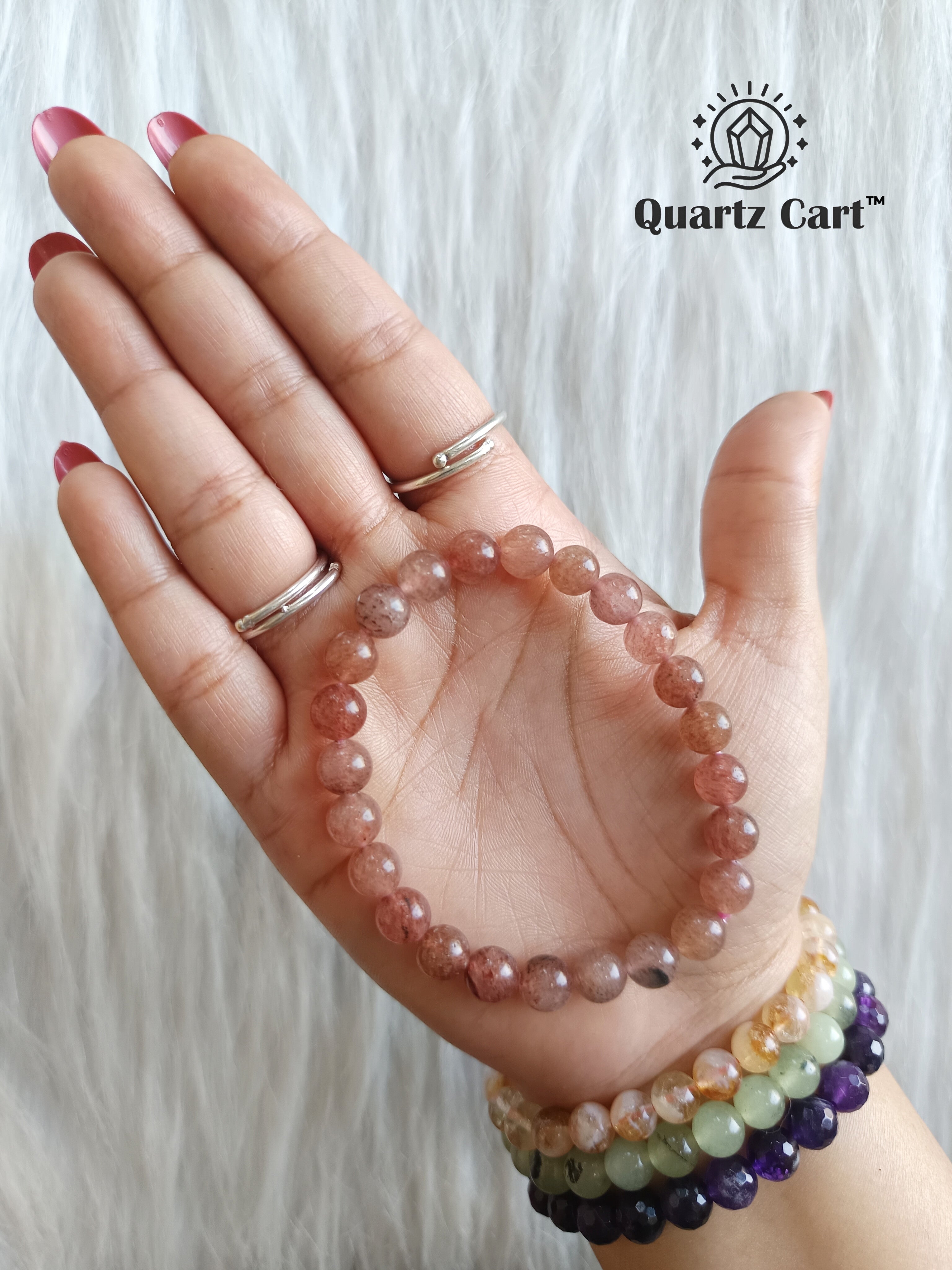 strawberry quartz bracelet on hand showing natural pink gemstone beads for love attraction and emotional healing