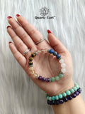 Hand holding Student Success healing crystal bracelet for focus concentration and exam success