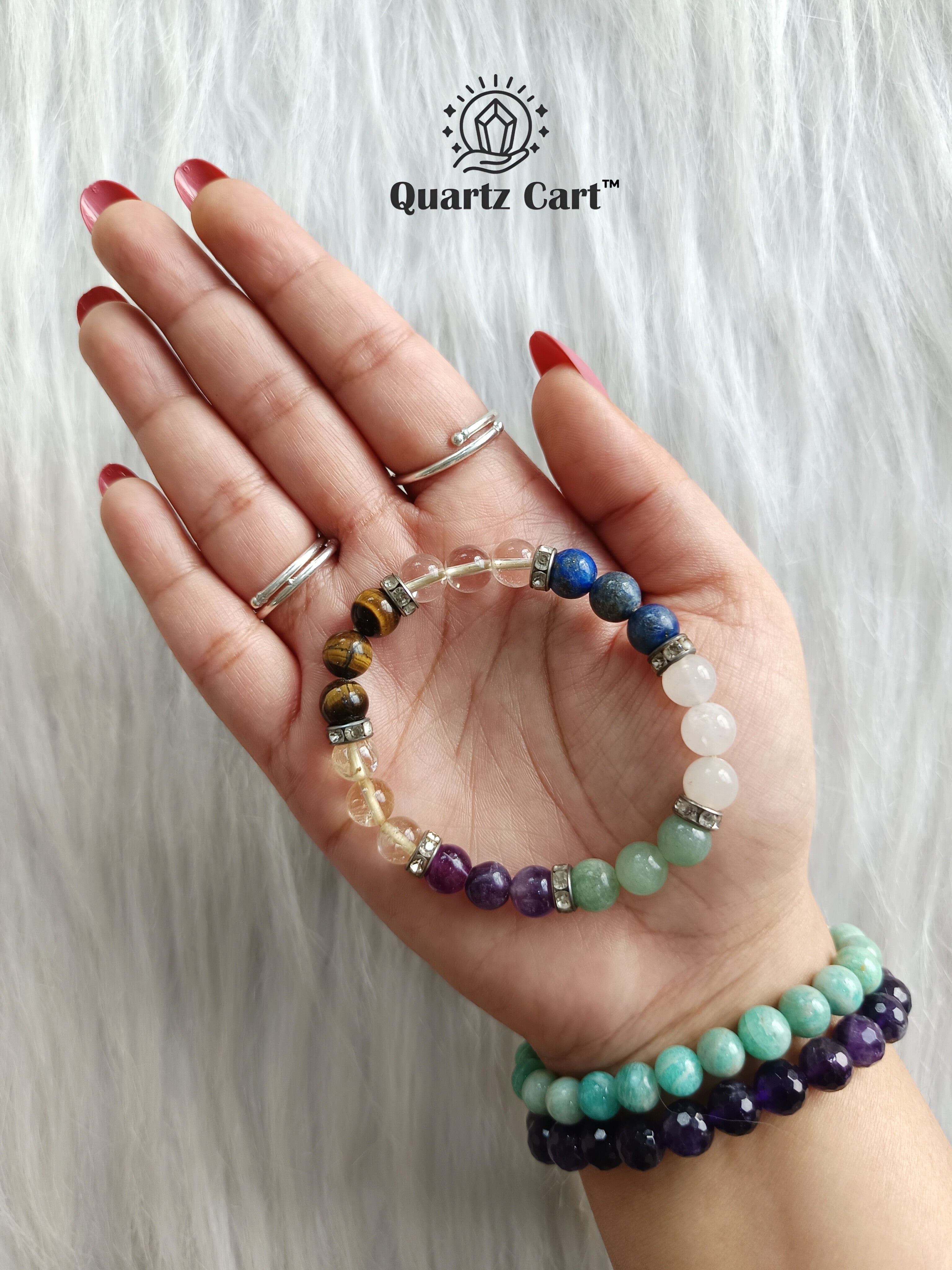Hand holding Student Success healing crystal bracelet for focus concentration and exam success
