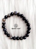 Sulemani Haqiq bracelet displayed on soft surface showing natural black gemstone beads, healing crystal bracelet for protection and positive energy
